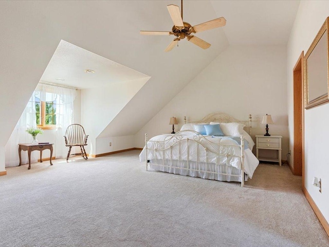 carpeted bedroom featuring vaulted ceiling, a ceiling fan, and baseboards