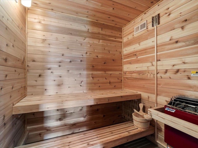 sauna / steam room with wooden walls and wooden ceiling