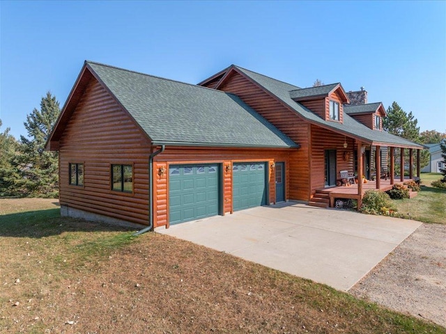 view of side of property with a porch, a garage, driveway, a shingled roof, and a chimney