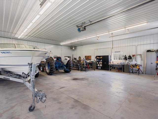 garage with a garage door opener and a workshop area