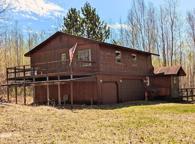 3333 Randa Rd, Orr, MN 55771 - rear view of house featuring a lawn, a deck, and an attached garage