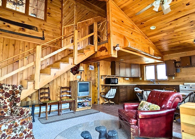 3333 Randa Rd, Orr, MN 55771 - living room with wood walls, wooden ceiling, stairway, high vaulted ceiling, and ceiling fan