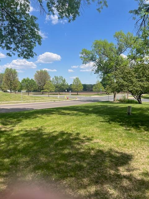 view of property's community with a lawn
