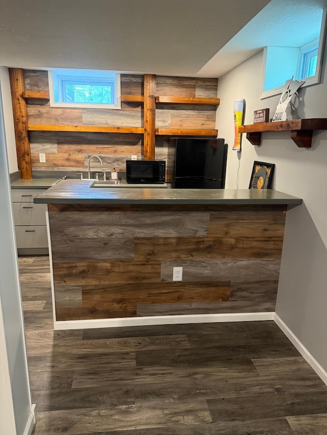 7000 164th Ave NW, Ramsey, MN 55303 - bar area with black appliances, a sink, wood finished floors, and baseboards