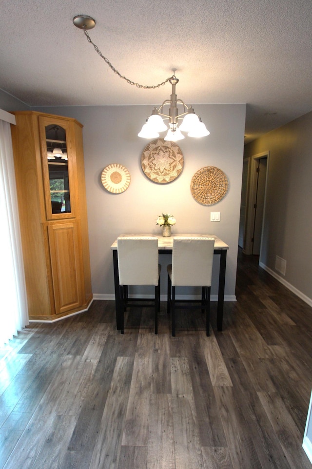 7000 164th Ave NW, Ramsey, MN 55303 - dining space with a chandelier, a textured ceiling, dark wood-type flooring, and baseboards
