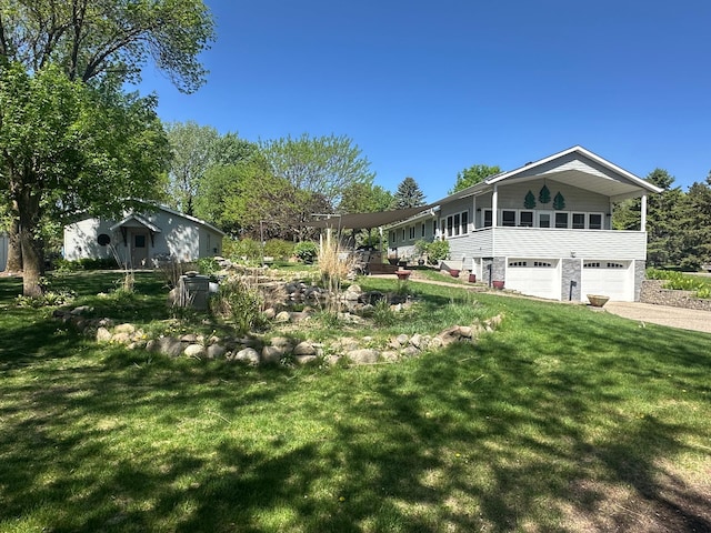 4220 23rd St NW, Willmar, MN 56201 - view of green lawn with a garage and driveway