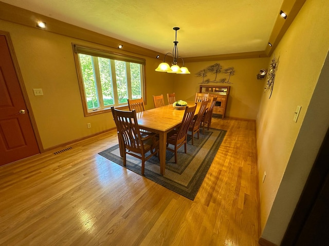 4220 23rd St NW, Willmar, MN 56201 - dining room featuring light wood-style floors, a chandelier, and baseboards