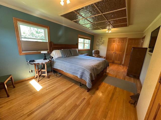 4220 23rd St NW, Willmar, MN 56201 - bedroom featuring wood finished floors, crown molding, and baseboards