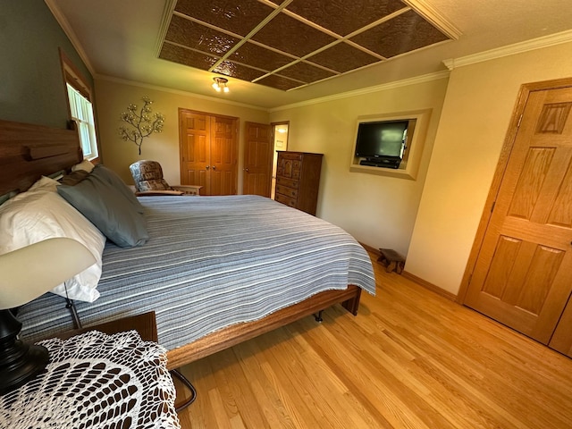 4220 23rd St NW, Willmar, MN 56201 - bedroom with wood finished floors, baseboards, a closet, and crown molding