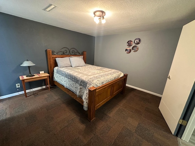 4220 23rd St NW, Willmar, MN 56201 - bedroom with a textured ceiling, dark colored carpet, and baseboards