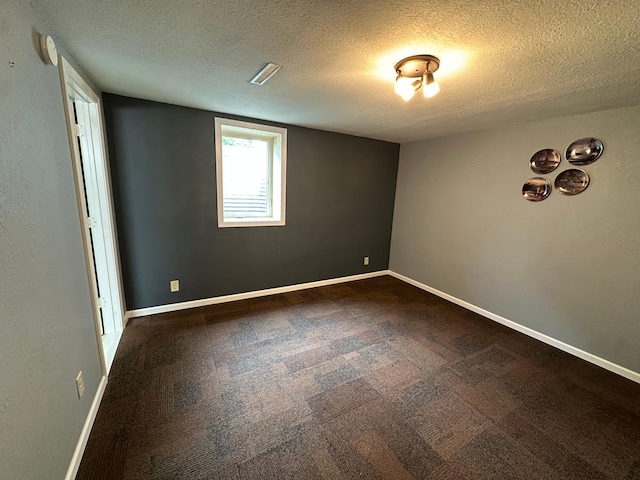 4220 23rd St NW, Willmar, MN 56201 - empty room with a textured ceiling, dark colored carpet, a smoke detector, and baseboards