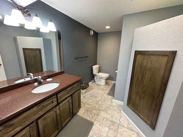4220 23rd St NW, Willmar, MN 56201 - bathroom with vanity, toilet, baseboards, and recessed lighting