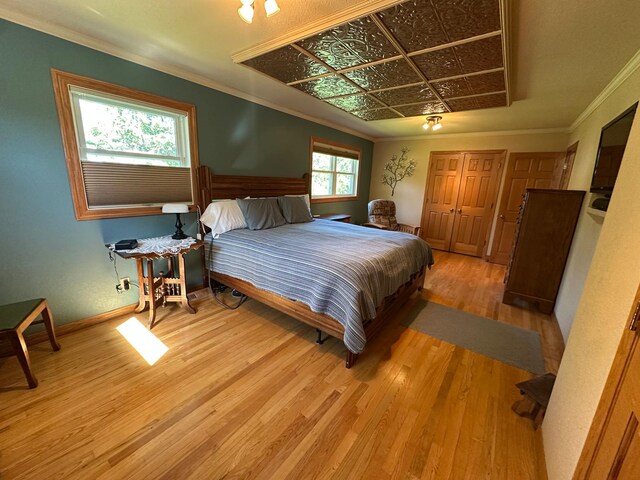 4220 23rd St NW, Willmar, MN 56201 - bedroom with wood finished floors, ornamental molding, and baseboards