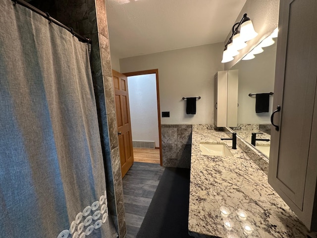 4220 23rd St NW, Willmar, MN 56201 - full bath with vanity, wood finished floors, and a shower with curtain