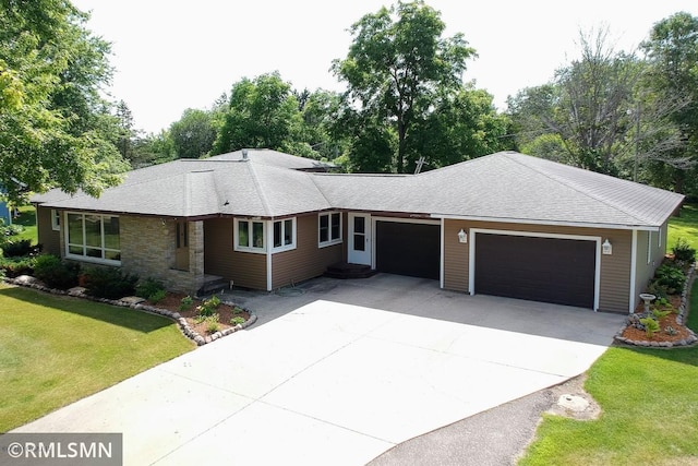 404 Clayborn Ave, Parkers Prairie, MN 56361 - ranch-style home featuring a garage, driveway, a front yard, stone siding, and a shingled roof