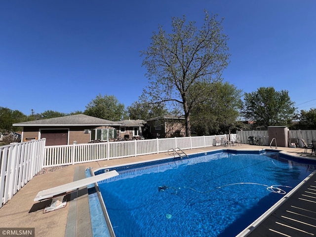 404 Clayborn Ave, Parkers Prairie, MN 56361 - view of swimming pool featuring fence, a diving board, and a patio area