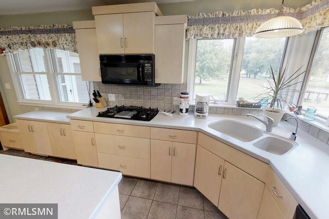 404 Clayborn Ave, Parkers Prairie, MN 56361 - kitchen with black appliances, a sink, light countertops, and plenty of natural light