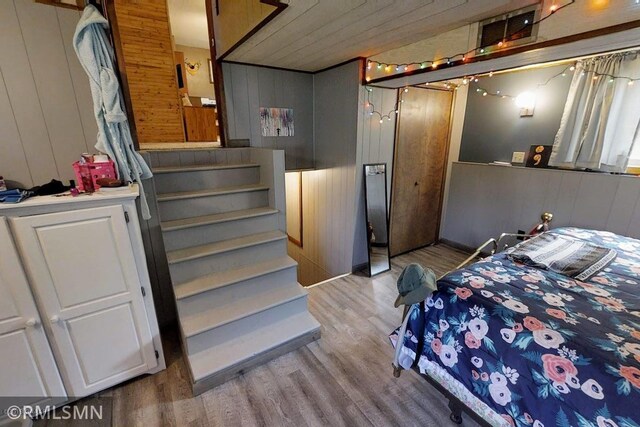 404 Clayborn Ave, Parkers Prairie, MN 56361 - bedroom featuring wood finished floors, wooden walls, and wooden ceiling