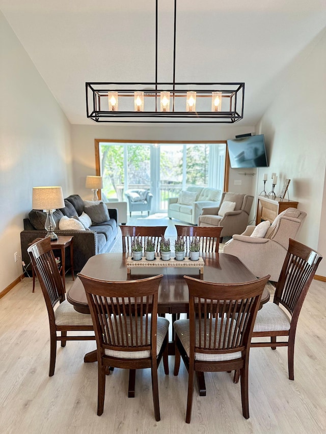 dining room with light wood-type flooring and baseboards