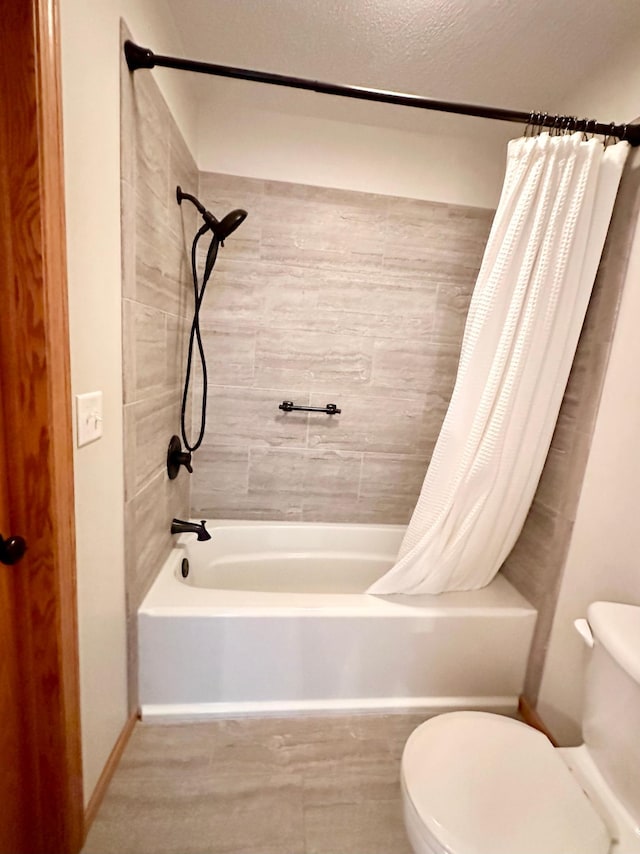 bathroom featuring toilet and shower / bath combo