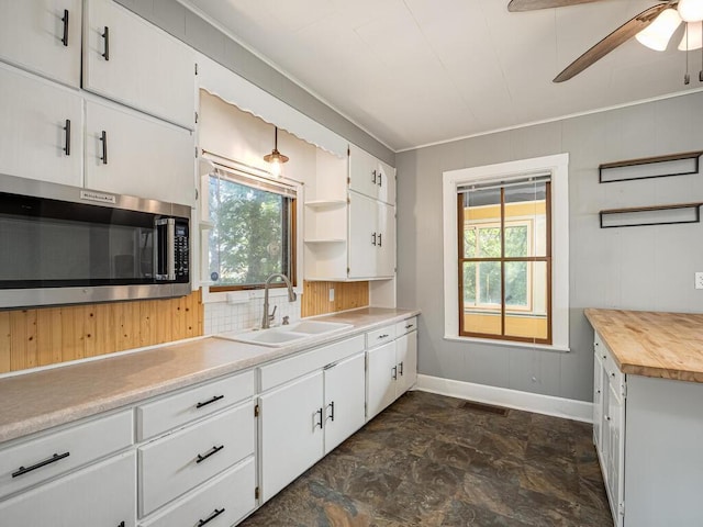 5844 Stagecoach Trl N, Oak Park Heights, MN 55082 - kitchen featuring stainless steel microwave, open shelves, plenty of natural light, white cabinets, and crown molding