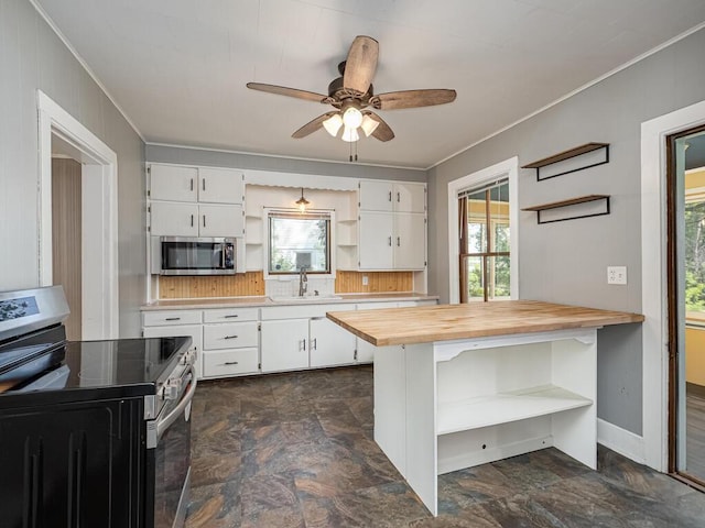 5844 Stagecoach Trl N, Oak Park Heights, MN 55082 - kitchen with open shelves, appliances with stainless steel finishes, butcher block counters, stone finish floors, and ornamental molding