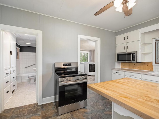 5844 Stagecoach Trl N, Oak Park Heights, MN 55082 - kitchen featuring appliances with stainless steel finishes, washer / clothes dryer, open shelves, white cabinetry, and a ceiling fan