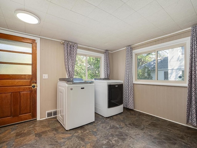 5844 Stagecoach Trl N, Oak Park Heights, MN 55082 - washroom featuring washing machine and dryer and wood walls