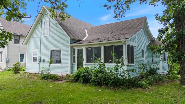5844 Stagecoach Trl N, Oak Park Heights, MN 55082 - view of side of home with roof with shingles, a yard, and a sunroom