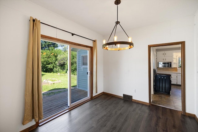 5844 Stagecoach Trl N, Oak Park Heights, MN 55082 - unfurnished dining area with a chandelier and dark wood finished floors