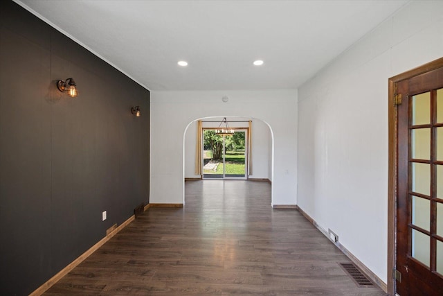 5844 Stagecoach Trl N, Oak Park Heights, MN 55082 - unfurnished room with arched walkways, dark wood-type flooring, and recessed lighting