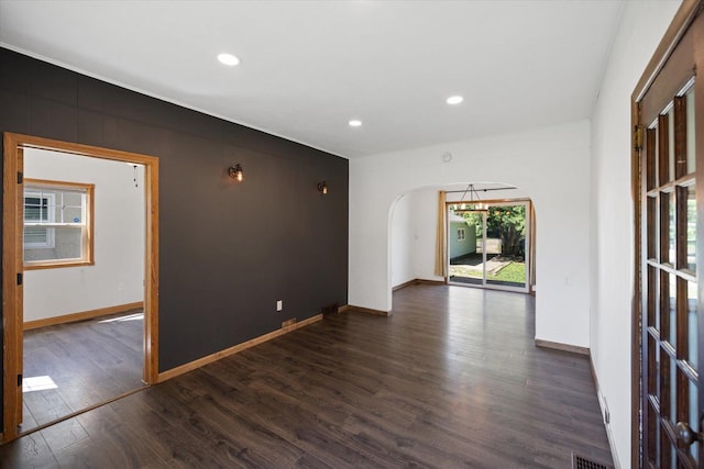 5844 Stagecoach Trl N, Oak Park Heights, MN 55082 - spare room with dark wood-type flooring, recessed lighting, and arched walkways