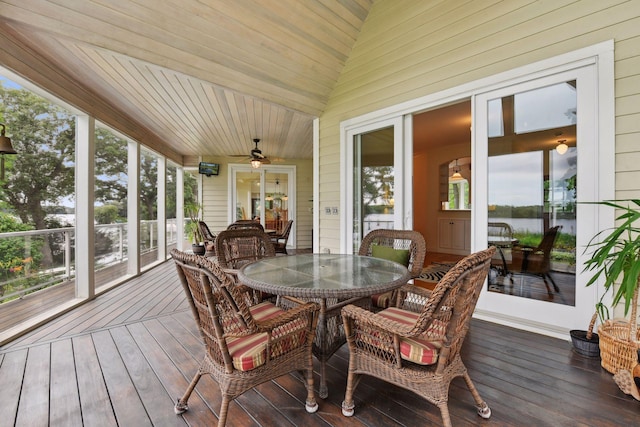 sunroom / solarium with outdoor dining space and ceiling fan