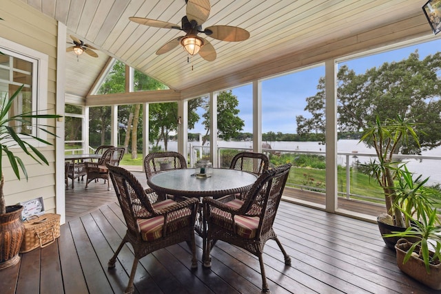 sunroom / solarium featuring outdoor dining area, ceiling fan, a water view, and lofted ceiling