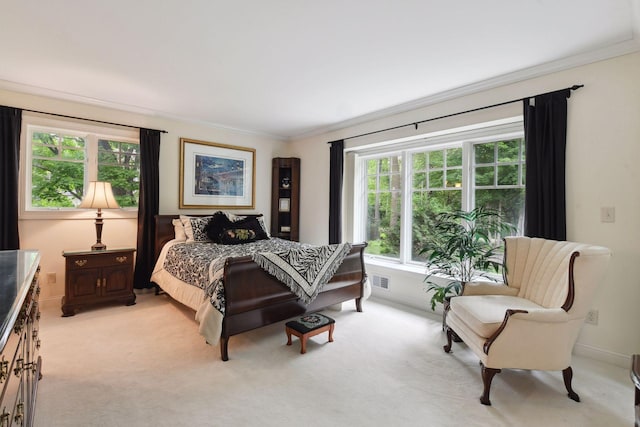 bedroom featuring crown molding, light carpet, and baseboards