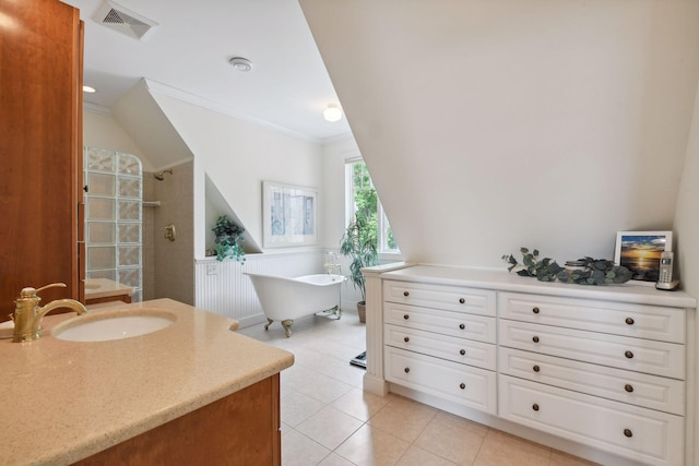 bathroom featuring tiled shower, tile patterned flooring, a freestanding tub, vanity, and crown molding