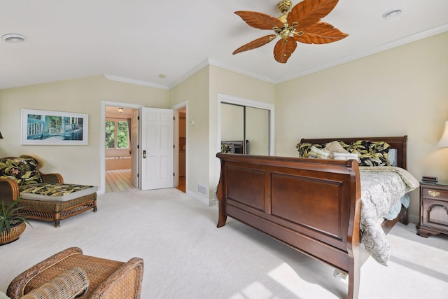 bedroom with light colored carpet, ornamental molding, a closet, baseboards, and ceiling fan
