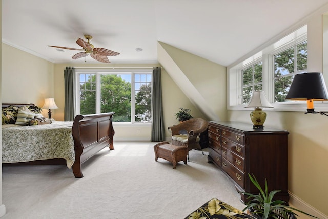 bedroom featuring light carpet, baseboards, a ceiling fan, and ornamental molding
