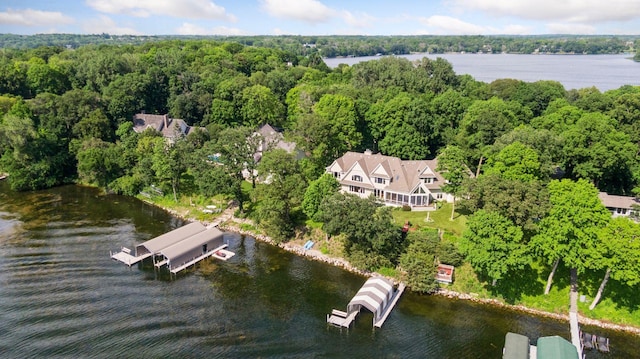 aerial overview of property's location featuring a large body of water and a heavily wooded area