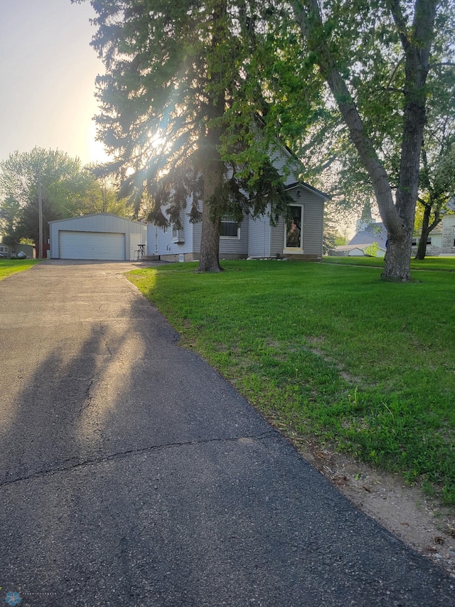26 5th Ave SE, Lidgerwood, ND 58053 - view of property hidden behind natural elements with a lawn and a detached garage