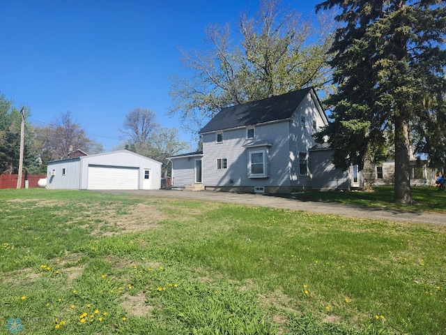 26 5th Ave SE, Lidgerwood, ND 58053 - rear view of property featuring a garage, an outbuilding, and a lawn