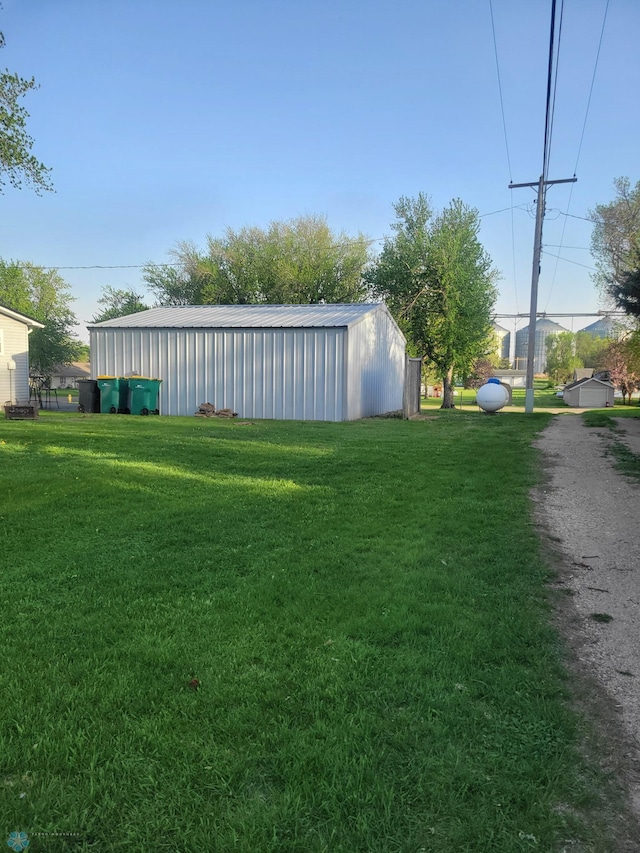 26 5th Ave SE, Lidgerwood, ND 58053 - view of green lawn featuring a pole building and an outdoor structure