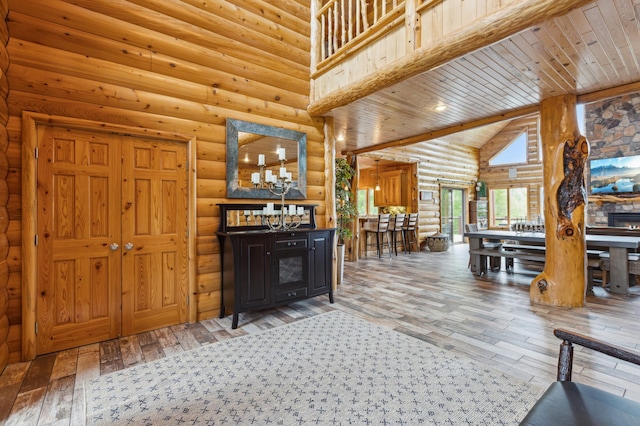 5784 Mcgowan Rd, Brainerd, MN 56401 - living room featuring hardwood / wood-style flooring, rustic walls, wooden ceiling, and high vaulted ceiling