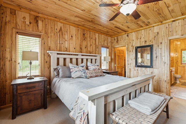5784 Mcgowan Rd, Brainerd, MN 56401 - bedroom featuring wooden walls, multiple windows, wood ceiling, ensuite bath, and carpet flooring