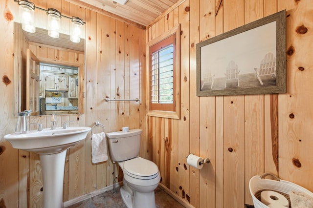 5784 Mcgowan Rd, Brainerd, MN 56401 - half bathroom featuring toilet and wood walls