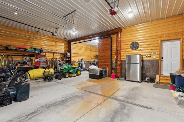 5784 Mcgowan Rd, Brainerd, MN 56401 - garage featuring freestanding refrigerator and a garage door opener