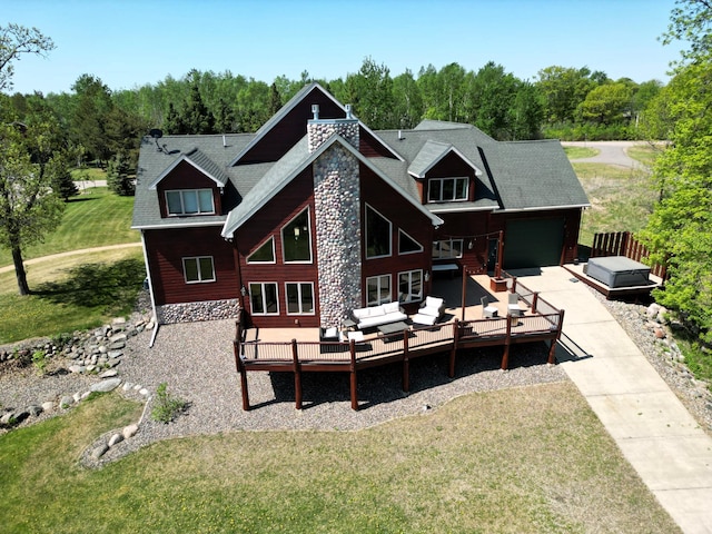 5784 Mcgowan Rd, Brainerd, MN 56401 - rear view of property featuring outdoor lounge area, a lawn, a garage, a wooden deck, and concrete driveway