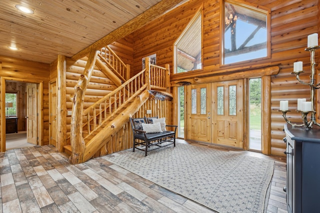 5784 Mcgowan Rd, Brainerd, MN 56401 - entryway featuring log walls, stairway, hardwood / wood-style floors, a high ceiling, and wood ceiling