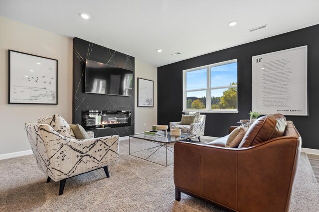 living area featuring baseboards, a premium fireplace, recessed lighting, and carpet floors