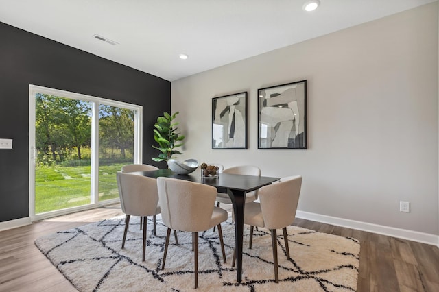 dining area featuring wood finished floors, baseboards, and recessed lighting